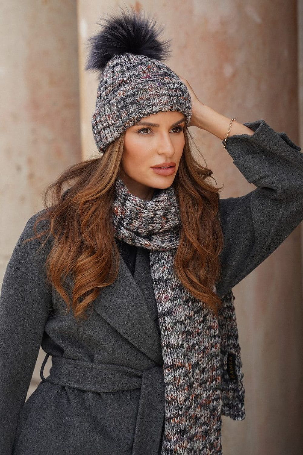 Model wearing the Kamea Pavone hat paired with a matching scarf, epitomizing luxury and warmth in winter fashion.