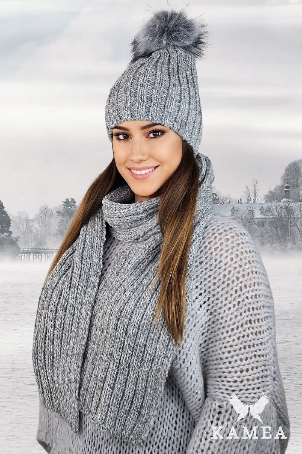 Elegant Kamea WEZYR Winter Hat in navy blue with a soft faux fur pompom, crafted for warmth and sophistication during the colder months.