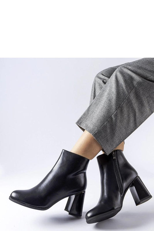 Solea elegant black insulated heel boots with a decorative Clivi heel showcasing a sophisticated almond toe and stylish stiletto heel.