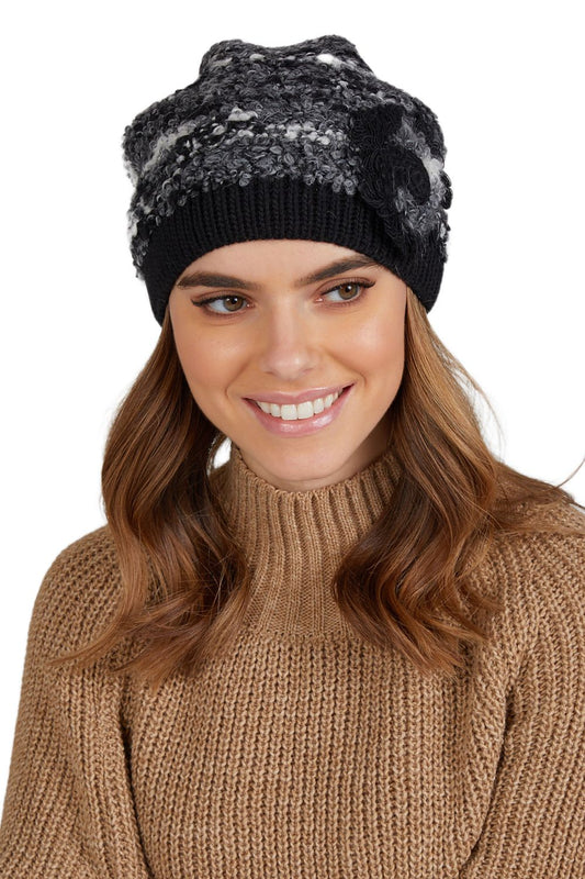 Stylish Kamea women's winter hat in two-tone bouclé with a unique handmade crochet flower detail, perfectly designed for comfort and luxury during cold days.