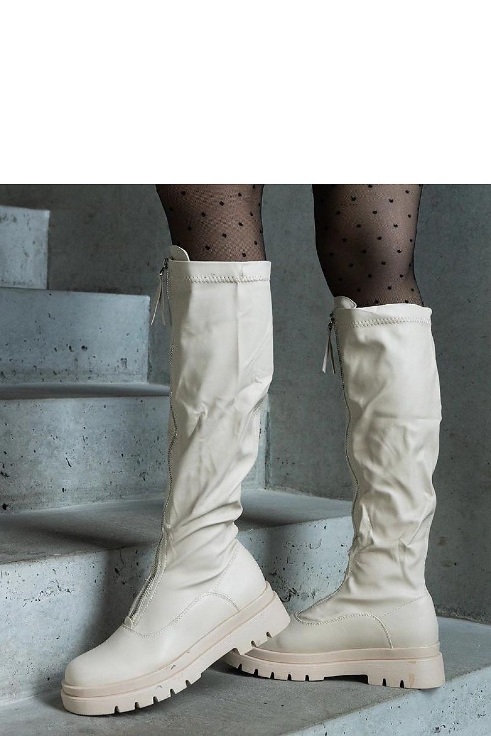 Chic Solea beige eco-leather thigh-high boots highlighted by a stylish Hala zipper, showcasing a sophisticated flat heel design.