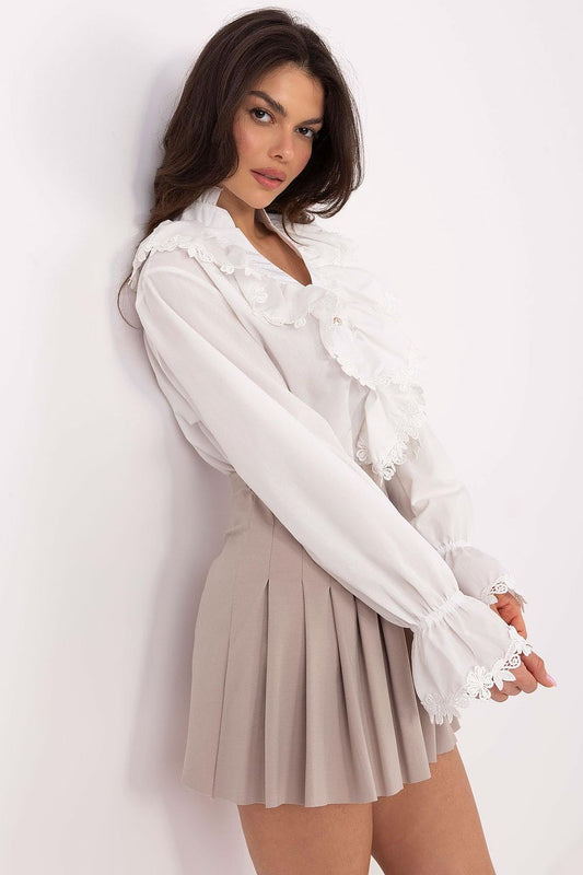 Close-up of the delicate lace cuffs on the Lakerta long sleeve shirt, highlighting the luxurious craftsmanship and feminine details.