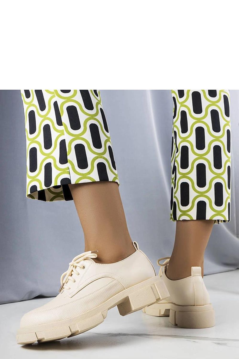 Pair of luxurious Solea eco-leather half shoes on a striking tractor sole, ideal for eco-conscious style enthusiasts.