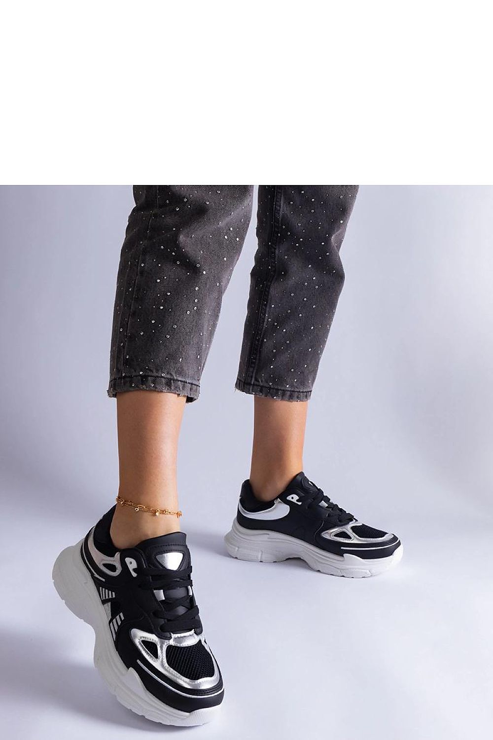 Sophisticated Solea black sneakers for women, highlighting silver embellishments, epitomising comfort and modern style in a designer look.