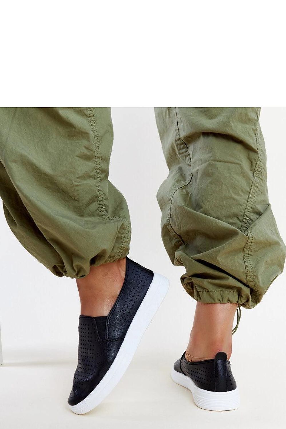 Chic Solea white slip-on sneakers for women, featuring a modern design and comfortable slip-on style, perfect for everyday luxury fashion.