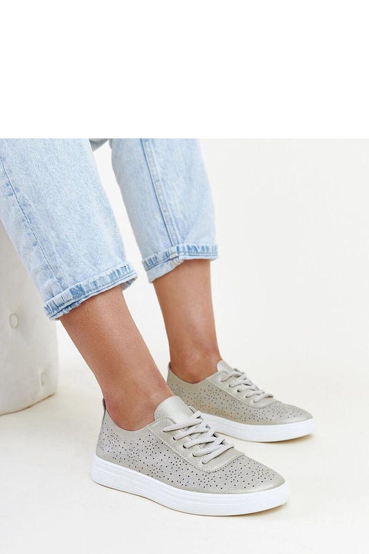 Elegant Solea golden eco leather Whitley sneakers displayed prominently, featuring a durable rubber sole and classic rounded toe, ideal for sophisticated everyday style.