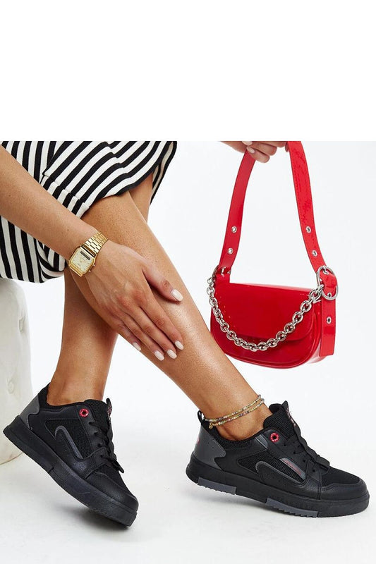 Close-up of Solea Ladies' black and grey sneakers, highlighting the quality materials and modern low design ideal for elegant casual wear.