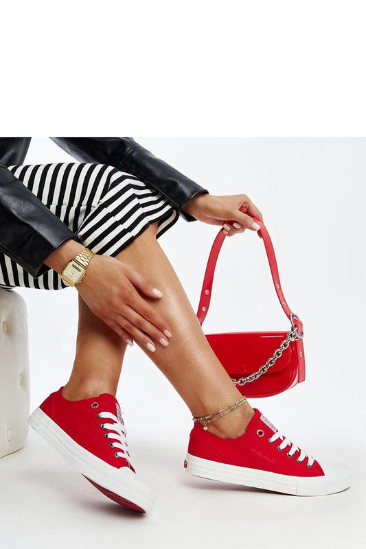 Close-up design of Solea's luxurious red lace-up sneakers showcasing premium fabric and a chic rounded toe.