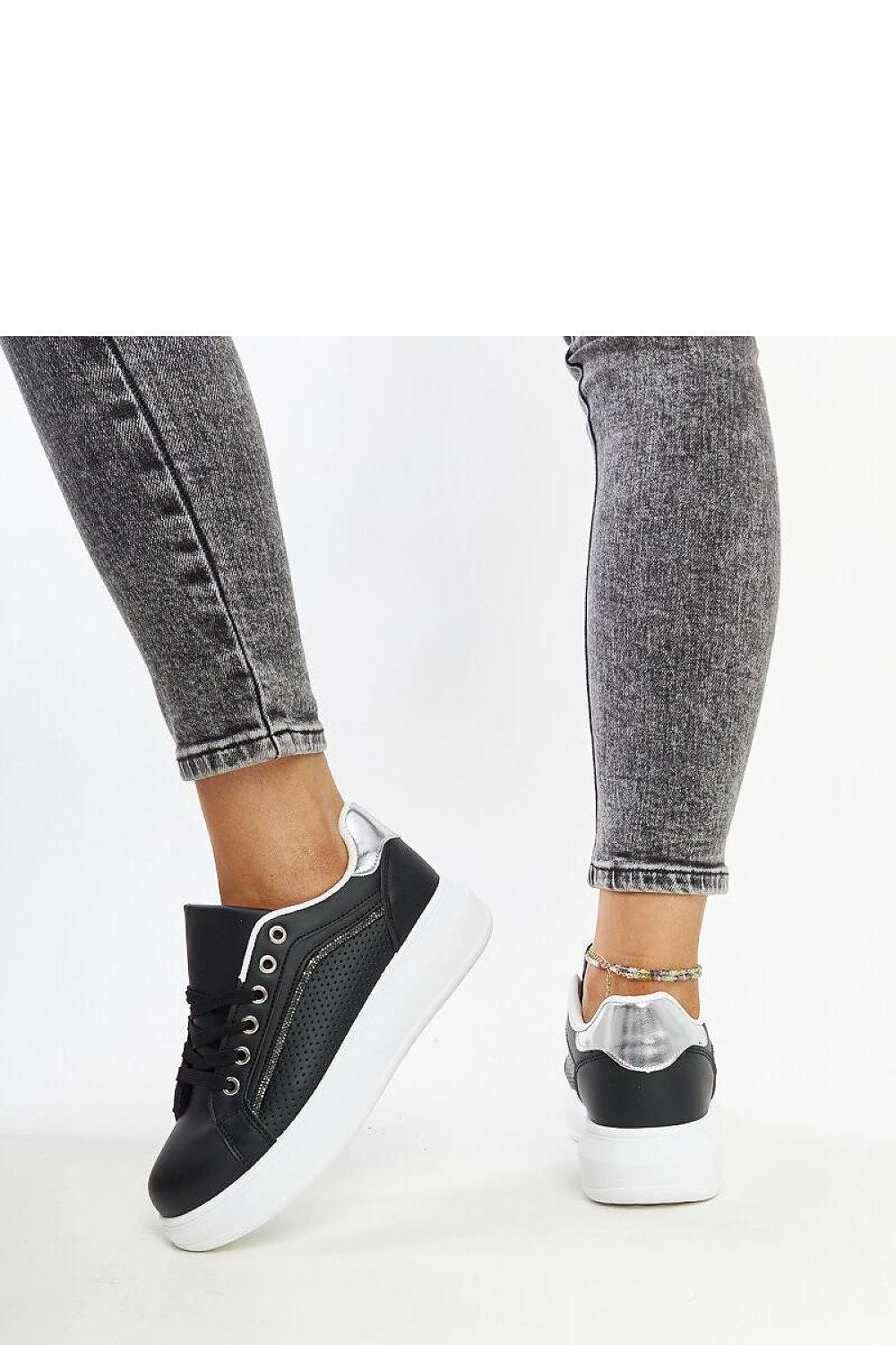 Side view of Solea luxury sneakers in elegant black eco leather, designed for women who appreciate unique style and comfort.