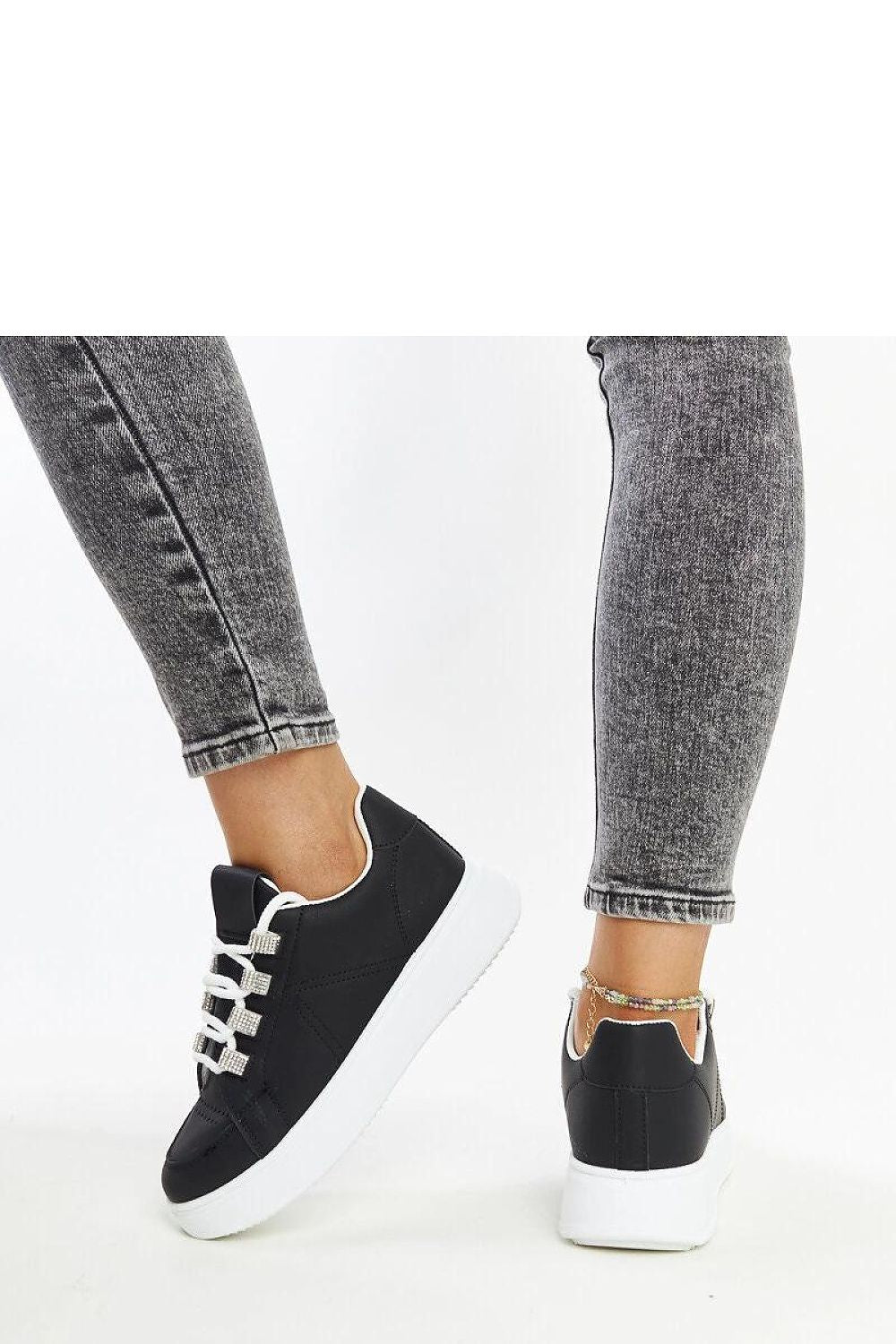 Elegant Solea black eco leather sneakers displayed with white detailing, highlighting versatility for summer and spring collections.