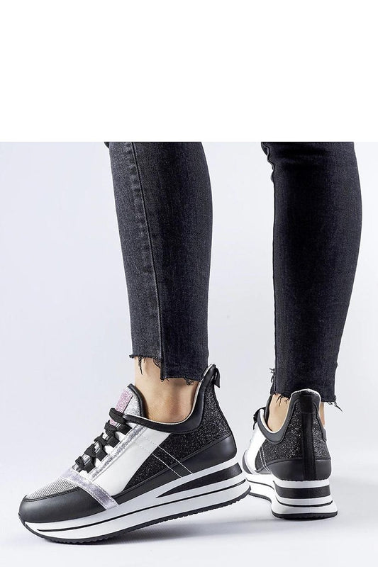 Elegant black platform sneakers by Solea crafted from eco leather, featuring a glittery finish, perfect for luxe summer styles.