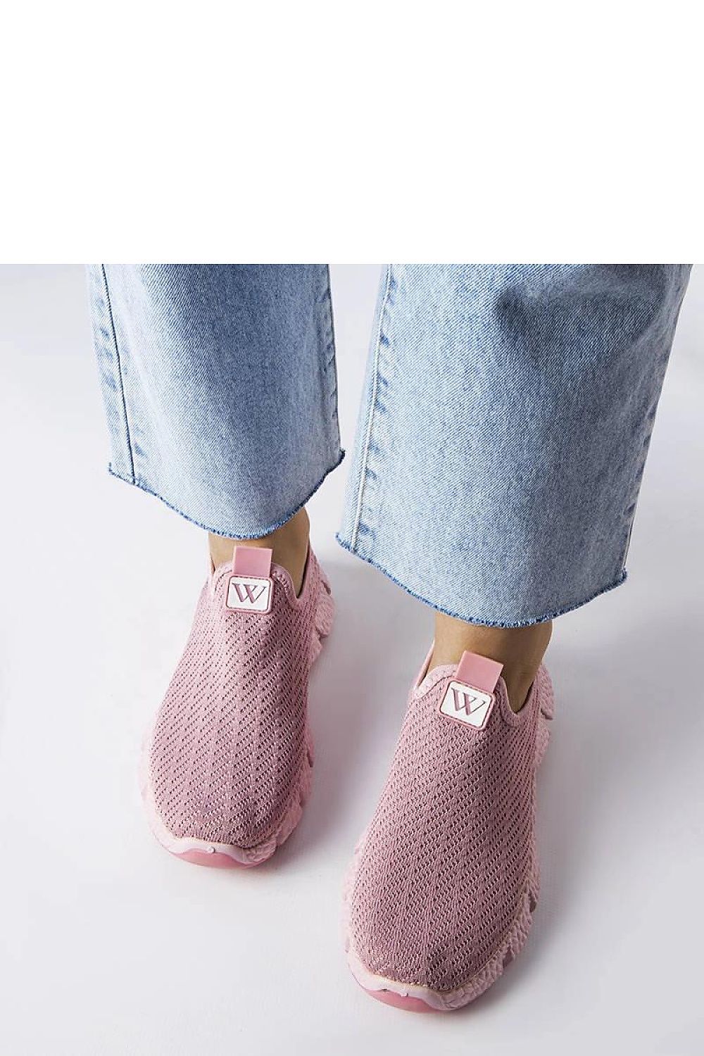 Solea women's pink slip-on sneakers displayed against a summer backdrop, ideal for chic casual outings.