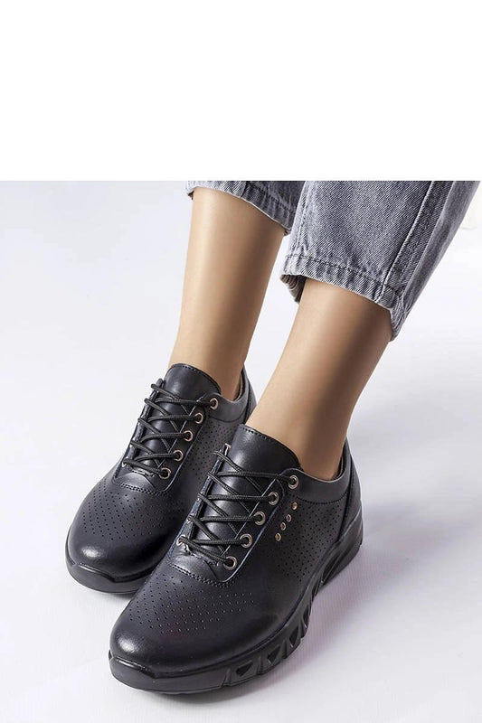 Close-up of Solea black leather cut-out sneakers, highlighting the natural leather quality and summer versatility.