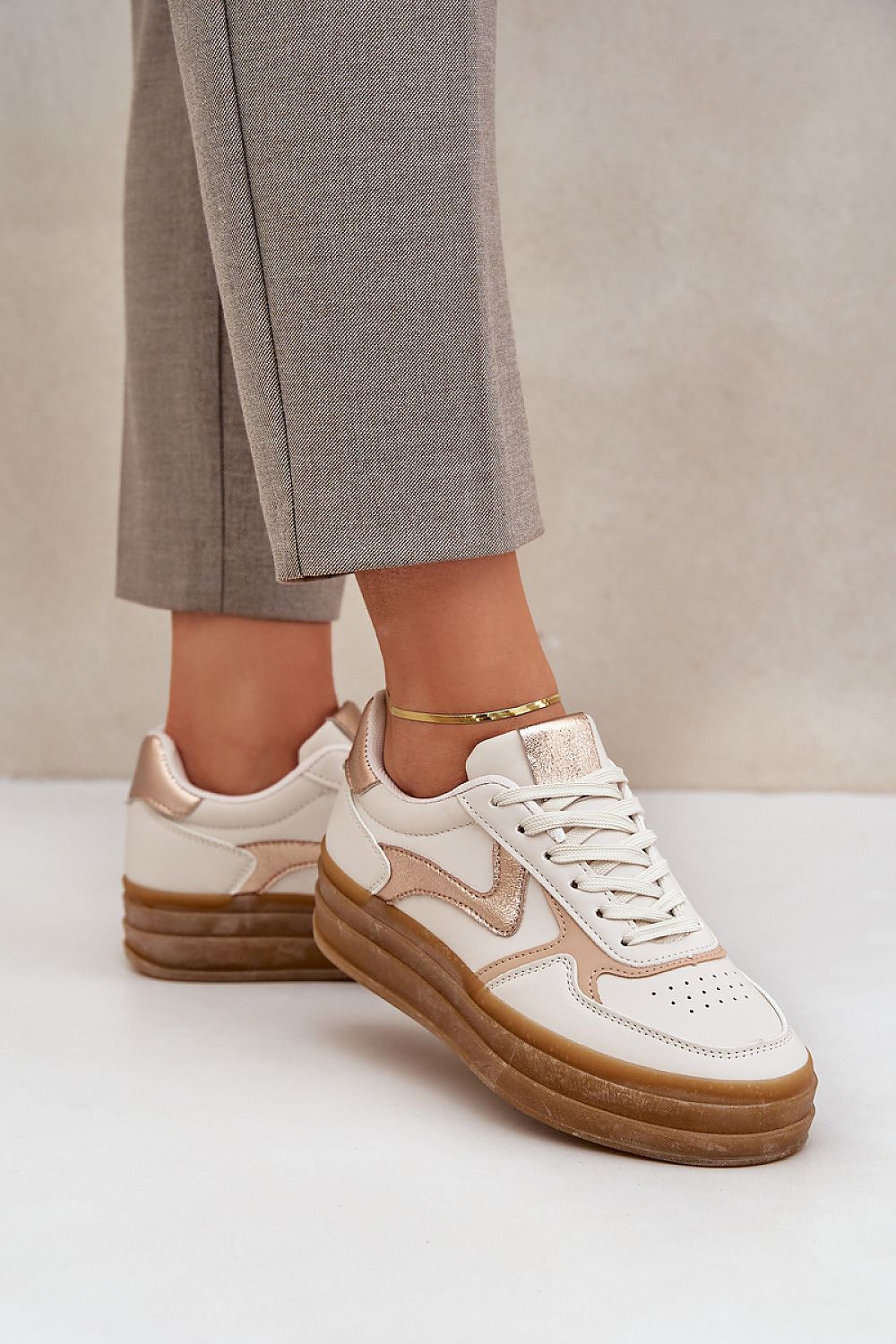 Stylish close-up of Luxury Women's Eco Leather Sneakers from Step in Style, showcasing the soft artificial leather and glamorous golden detailing, perfect for modern fashion.