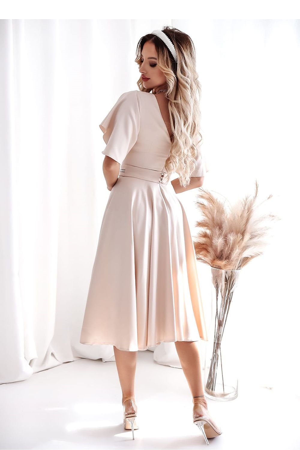 Stylish blue cocktail dress with ruffled sleeves and a decorative belt, designed by With You, suitable for weddings and receptions.