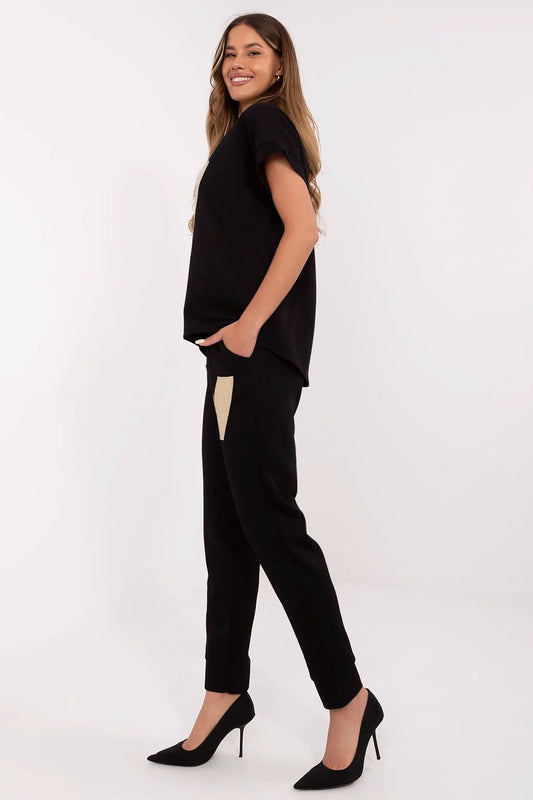 Close-up of Italy Moda's stylish women's comfort set showcasing the elegant detailing and luxurious fabric of the V-neck blouse paired with high-waisted pants.