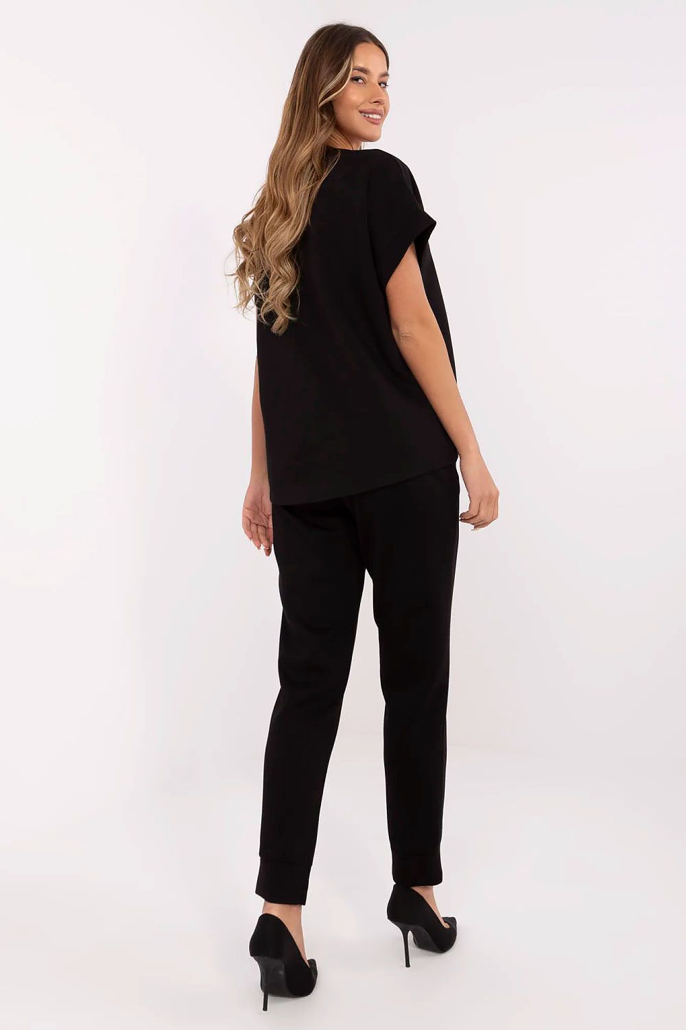 Model wearing the Italy Moda Women's Stylish Comfort Set, highlighting the sophisticated design of the V-neck blouse and high-waisted trousers, perfect for a fashionable lifestyle.