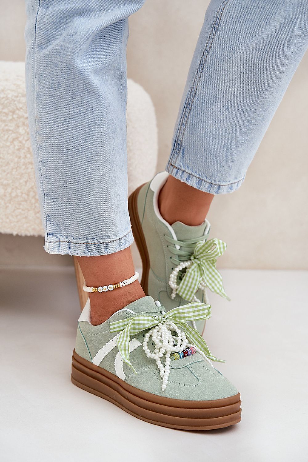 Charming detail of eco-suede platform sneakers featuring unique laces by Step in Style, designed to elevate everyday outfits.