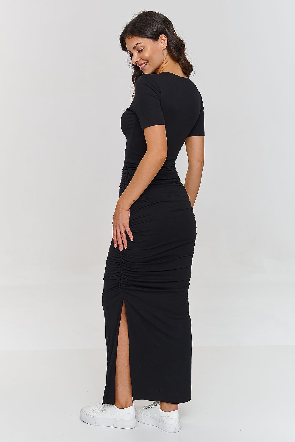 Chic and modern Makadamia maxi dress showcasing a V-neckline and ruches, suitable for a variety of elegant occasions.