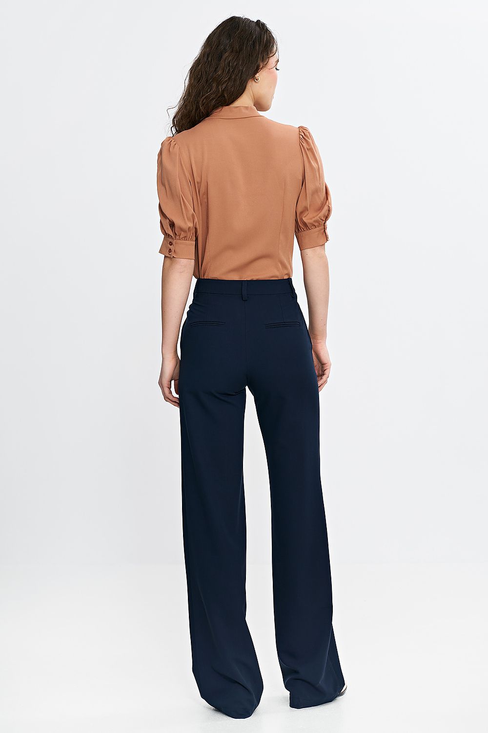 Stylish high-waist bootcut trousers by Nife displayed on a model, exuding elegance and versatility suitable for both office and casual outings.