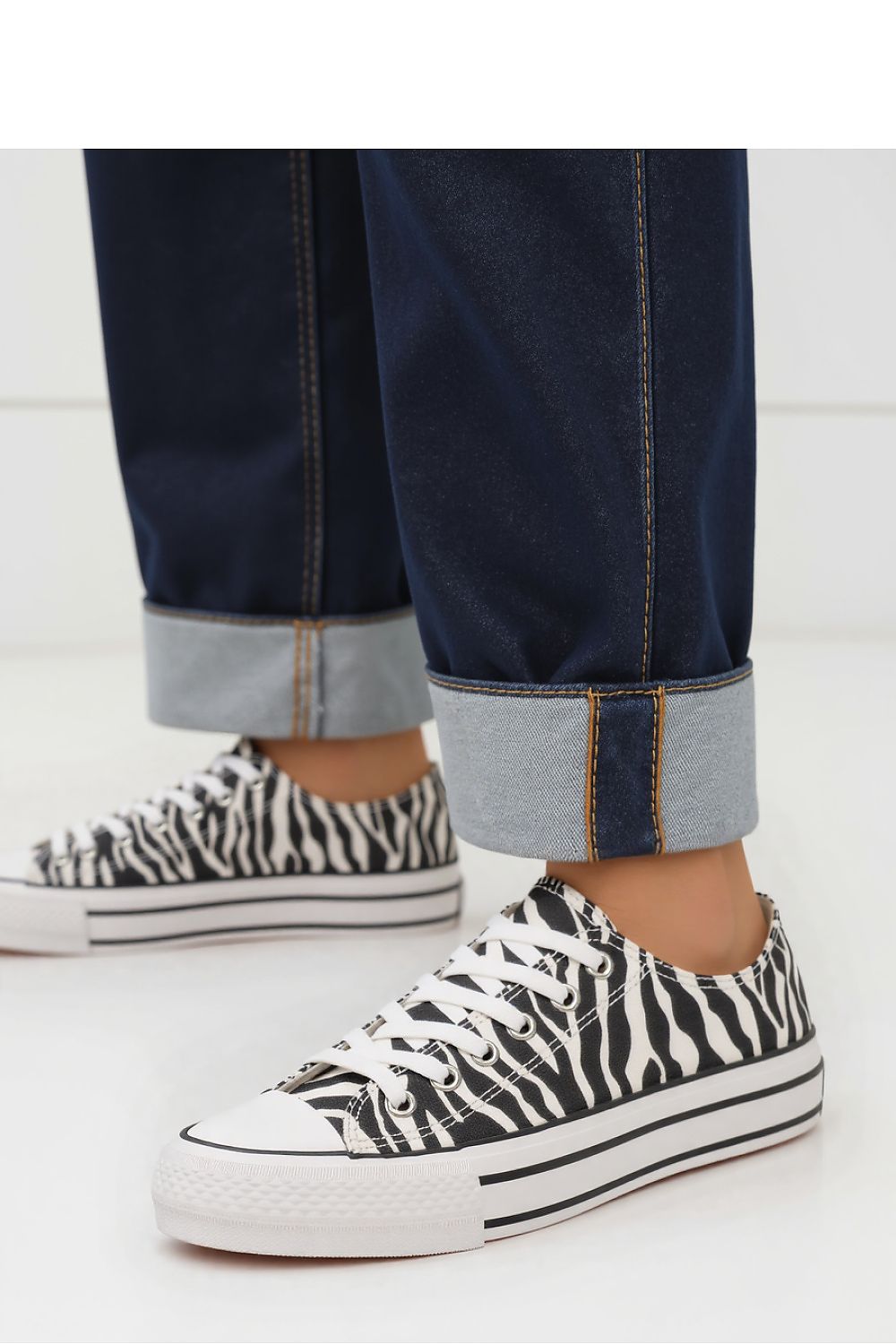 Lifestyle shot of Inello Savana Zebra Sneakers, epitomising luxury streetwear with a striking zebra print and sophisticated styling.