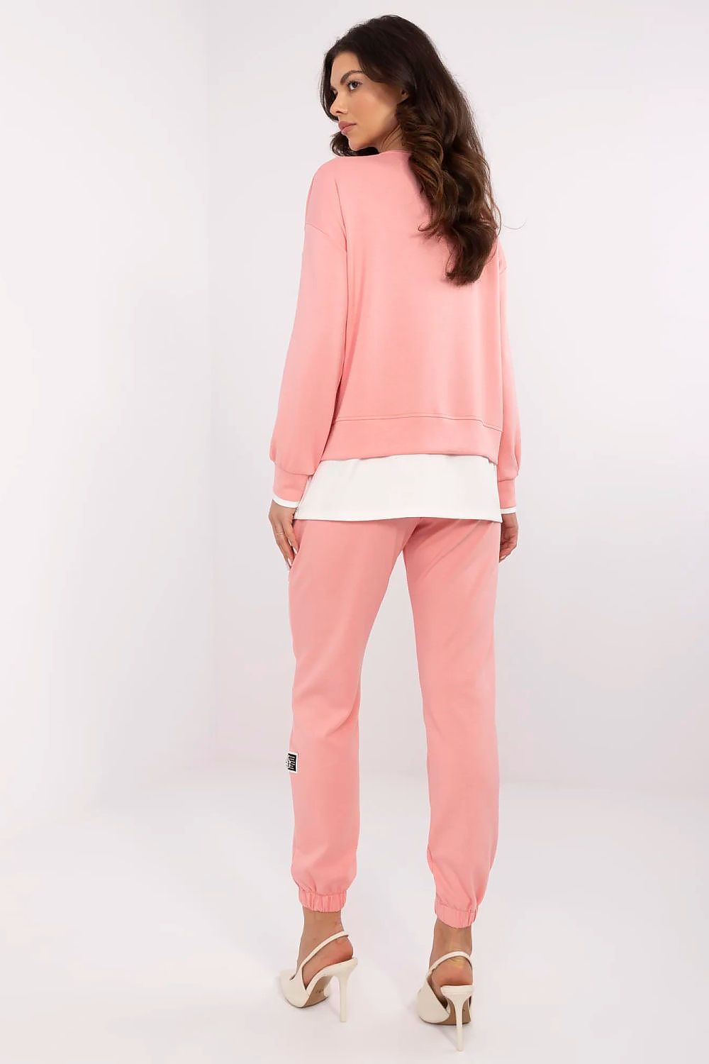 Chic luxury women's casual tracksuit set from Relevance, with a pink sweatshirt and high-waisted trousers, designed for both relaxation and stylish outings.