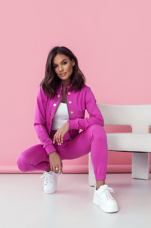 LaBalancia Women's Elegant Set in chic pink, model poses in a fashionable stance highlighting the sleek long trousers and elegant blouse. Captivating styling aimed at modern women who value sophistication and comfort.