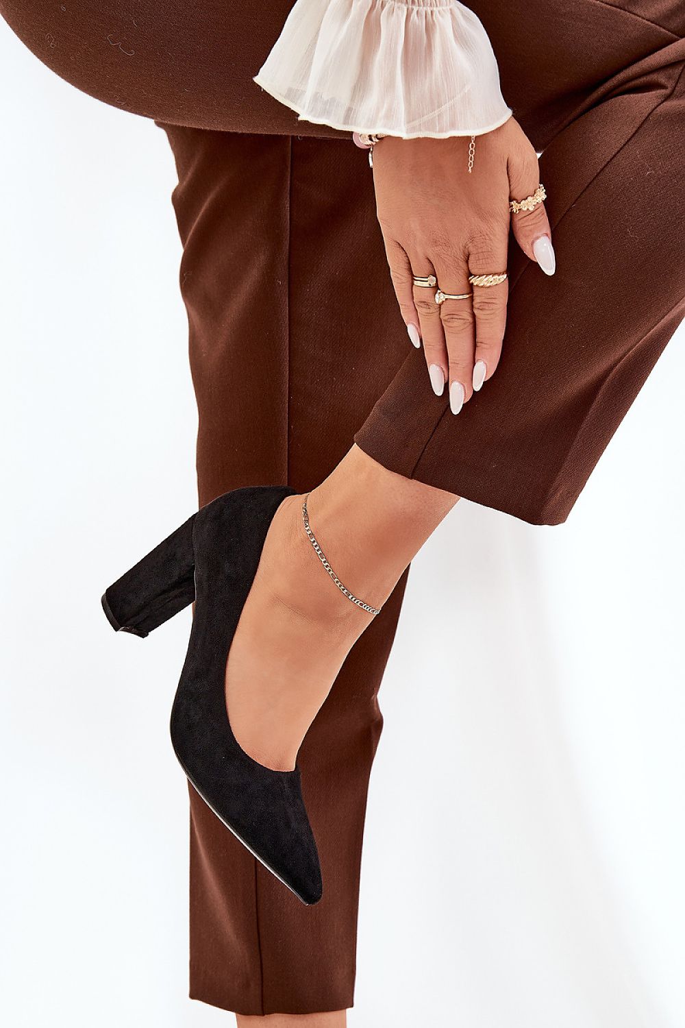 Fashionable black eco suede block heel pumps from Step in Style, styled elegantly with accessories on a model's foot, perfect for sophisticated attire.