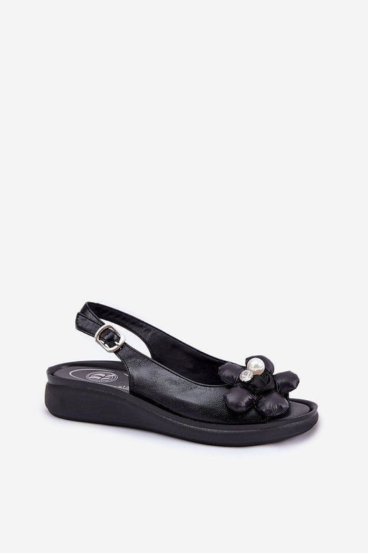 Close-up view of Step in Style eco-leather women's sandals with decorative flower accents and adjustable buckle strap, designed for comfort and stability.