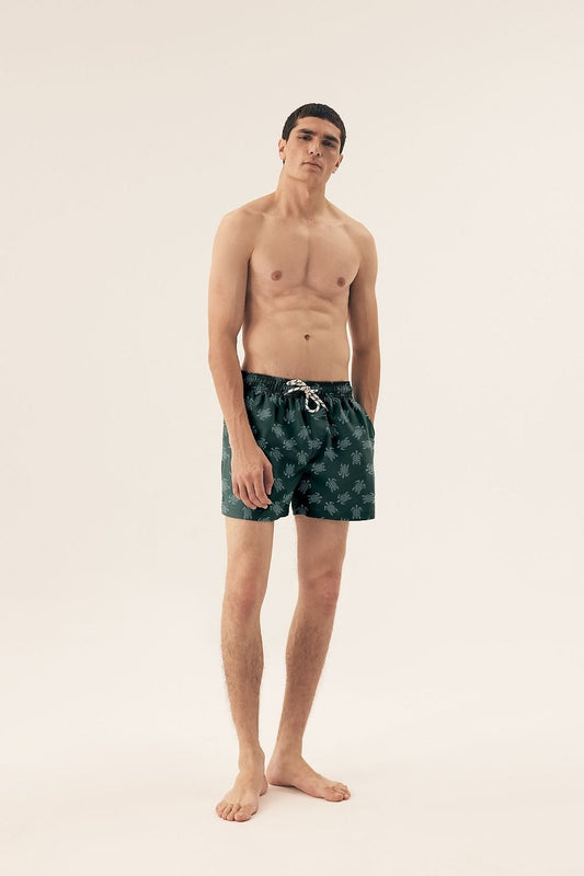 Close-up of Henderson Men's Elastic Waist Swim Trunks highlighting practical side pockets and elegant slits for enhanced movement.