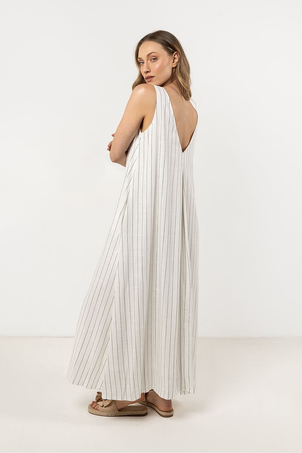 Delicate striped linen maxi dress from Awama, designed with a flowy silhouette and breathable cotton lining, ideal for a chic summer look.