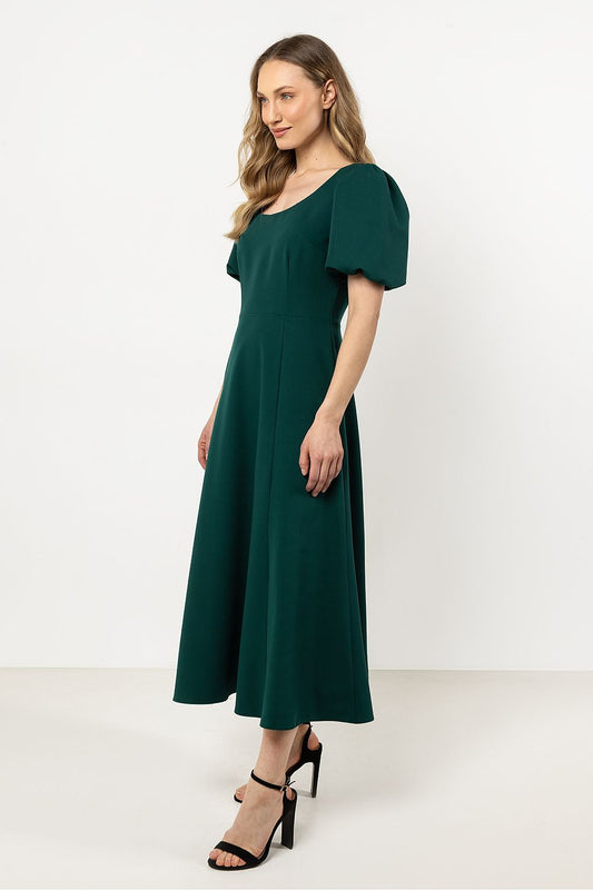 Elegant Awama Daydress featuring a deep neckline and flared bottom, showcasing luxurious comfort and sophisticated style.
