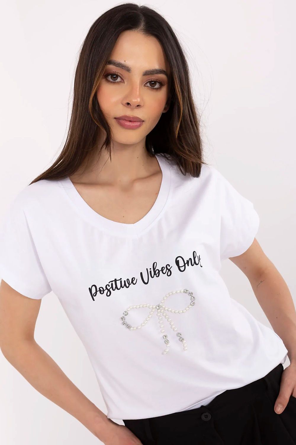 Close-up of the high-quality zircon decorations on a stylish women's cotton t-shirt by Factory Price, showcasing sophistication and comfort.
