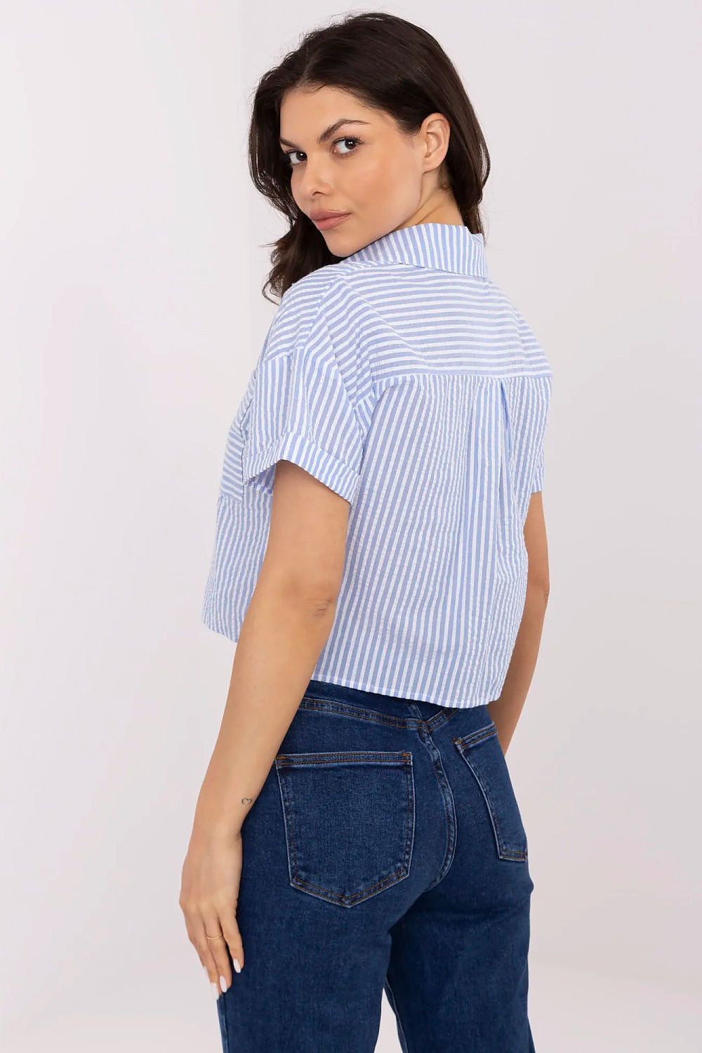 Detailed view of the practical chest pocket on NM's luxury striped cotton shirt for women, emphasising functionality and luxury.