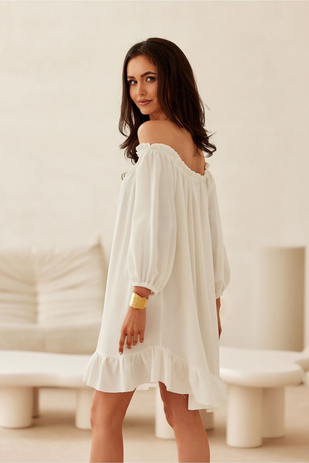 The Giulia Dress by Roco Fashion elegantly draped on a model, showcasing its flowy design and ruffle details for effortless summer charm.