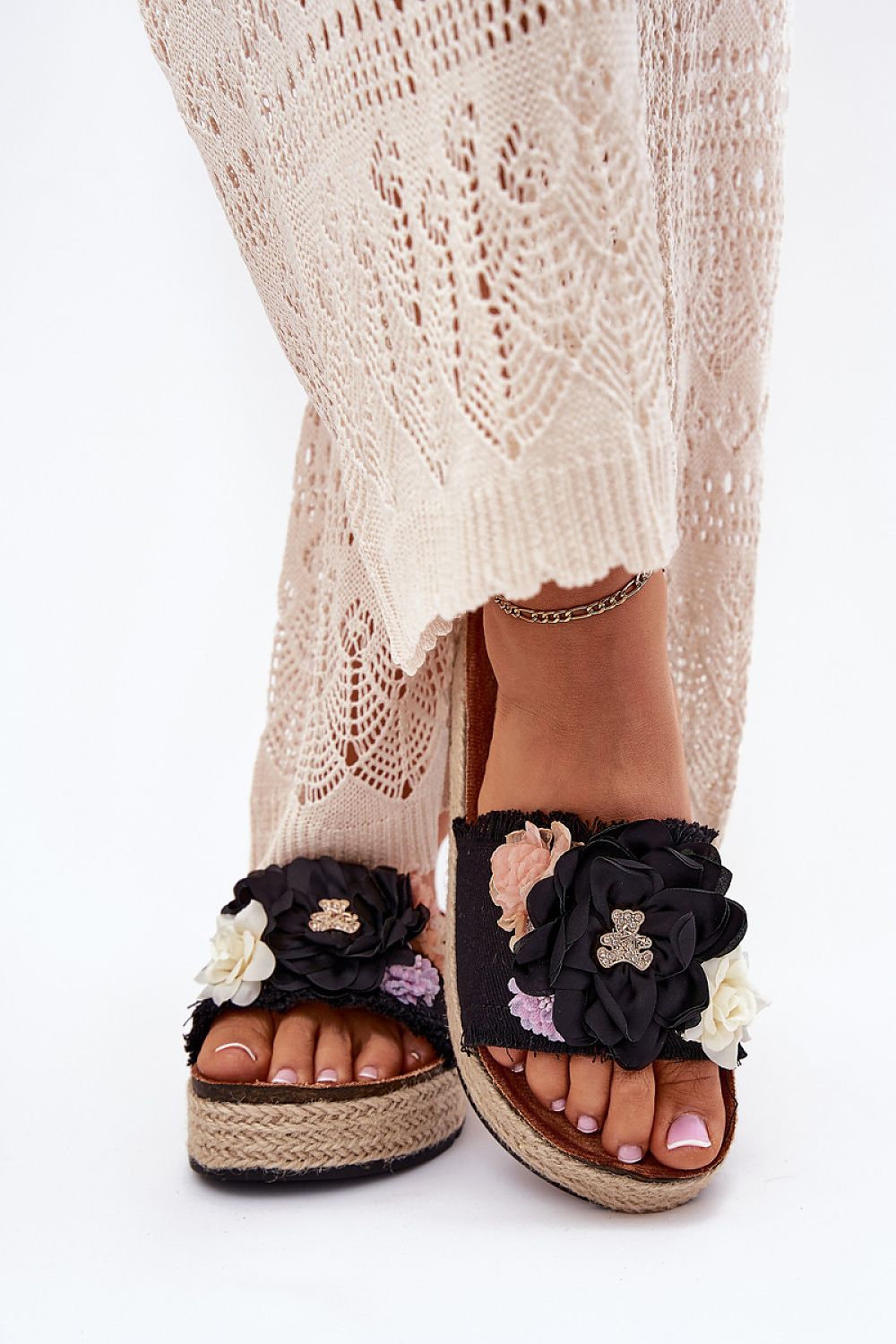 Luxury women's flip-flops by Step in Style, featuring a floral design and a charming teddy bear pin on a jute braided platform, perfect for summer styling.