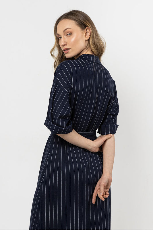 Close-up of the delicate striped fabric of the linen shirtdress by awama, highlighting its breathable texture and sophisticated design.