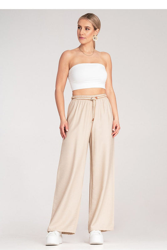 Close-up of Figl’s luxury Boho trousers showcasing the intricate braided belt detail and breathable fabric.