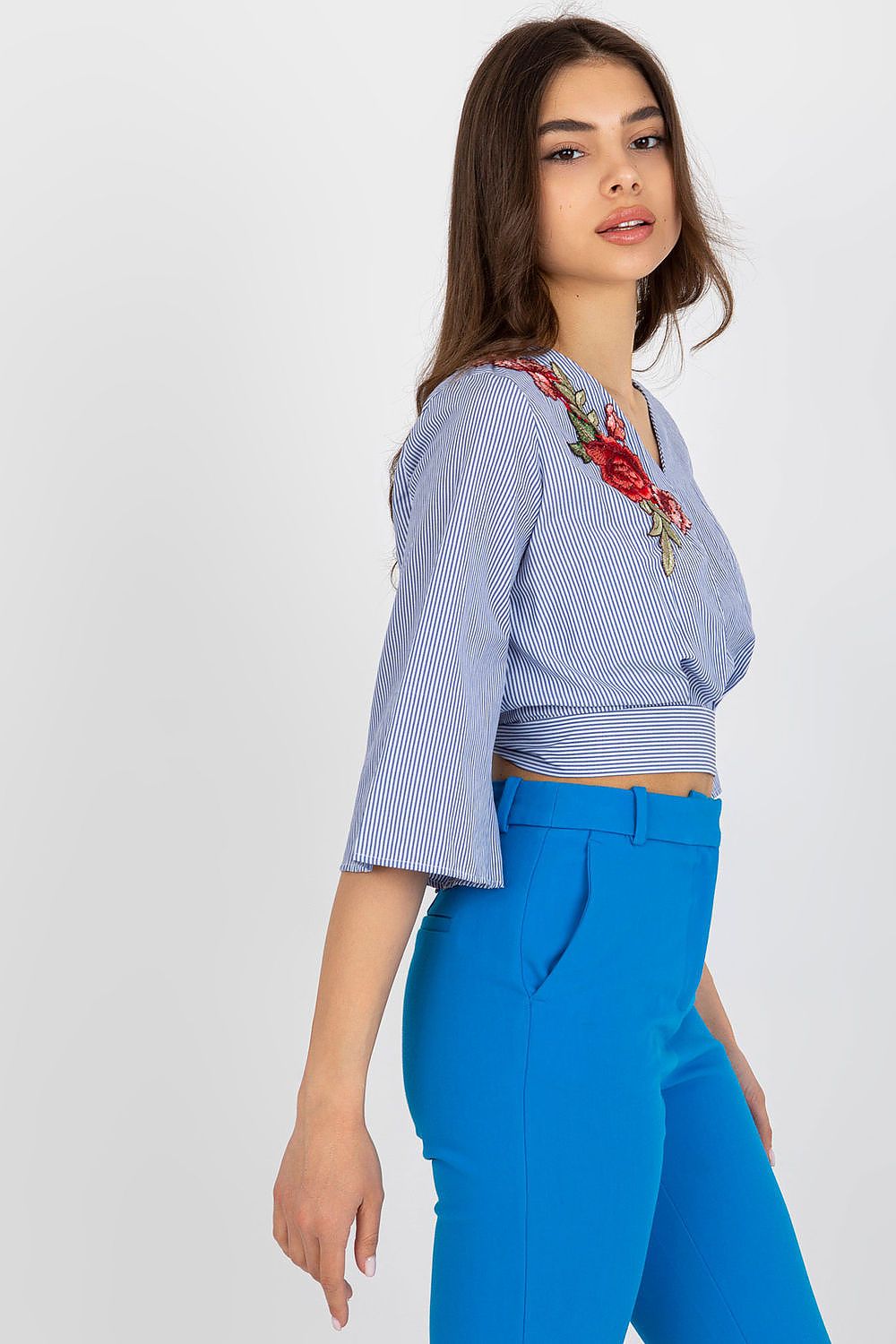 Stylish floral-accented cotton blouse in EU sizes 36-42 by Lakerta, ideal for warm weather and special occasions.