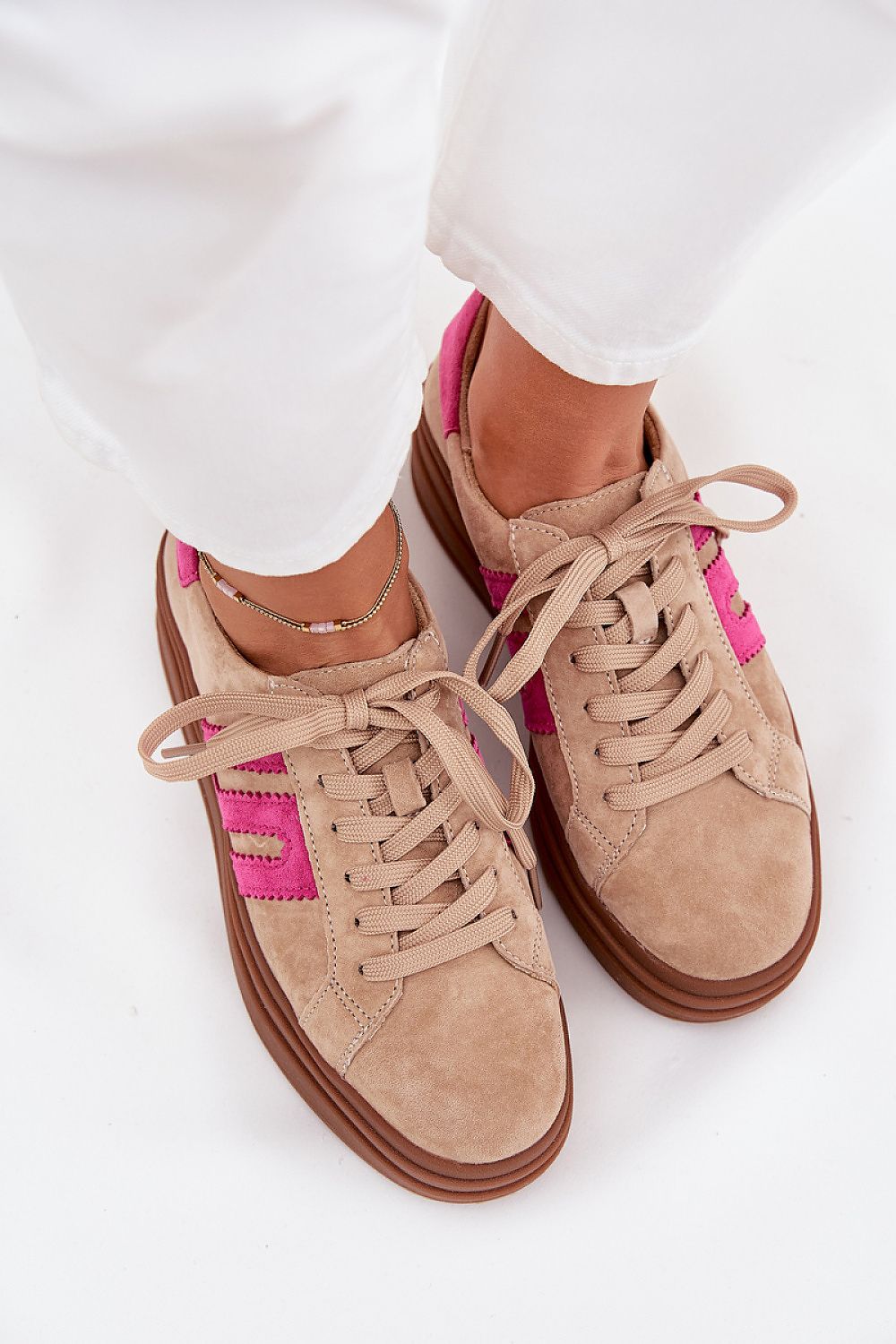 Step in Style luxury women's sneakers with a platform sole, highlighted against a chic backdrop, exemplifying elegance and modern flair.