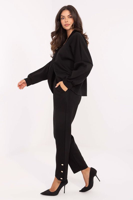 Close-up of the luxurious V-neck blouse from Rue Paris, made from soft viscose with elastane, showcasing its feminine design and button fastener.