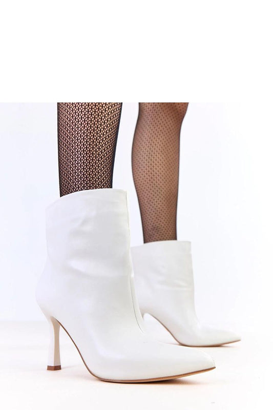 Solea high-heeled lacquered ankle boots in eco-friendly leather showcasing their elegant design and shiny finish.