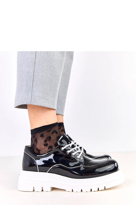 Stylish display of Solea Women's Polished Half Shoes showcasing the glossy finish and comfortable fit, perfect for modern urban elegance.