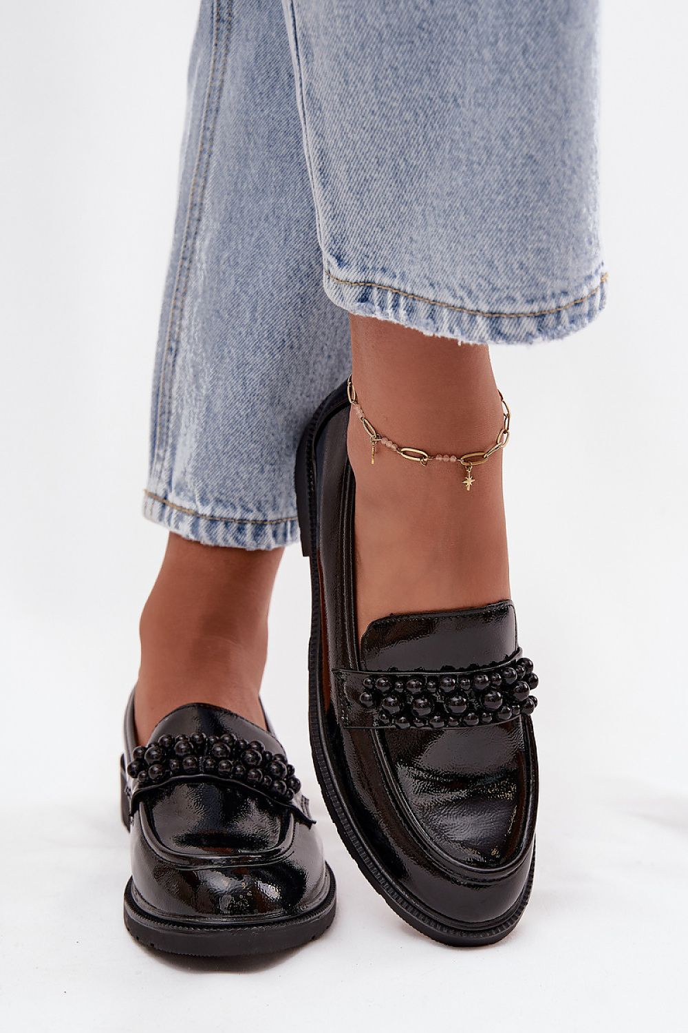 Stylish women's loafers in a fashionable setting, designed by Step in Style, perfect for both casual and elegant outfits.