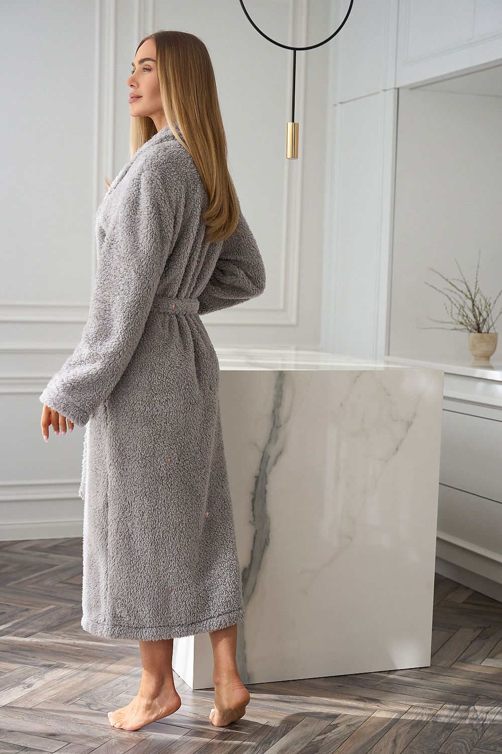 Model wearing luxury L&L collection women's bathrobe with adjustable waist tie, side pockets, and graceful mid-calf length, perfect for relaxed living.