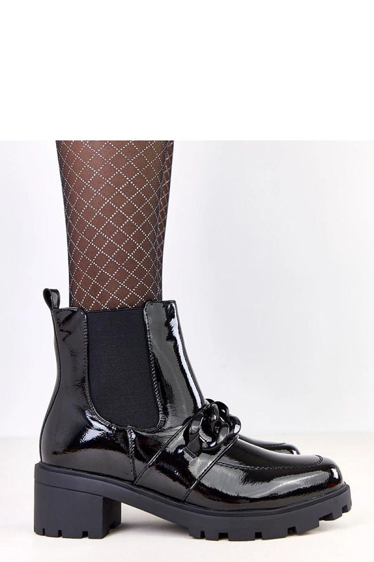 Stylish black eco-leather ankle boots from Solea, adorned with a decorative chain and showcasing a sophisticated design, perfect for modern elegance.