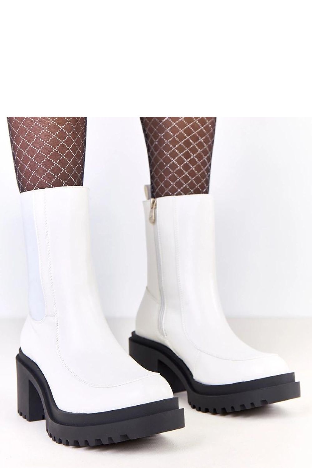 Versatile Solea ankle boots styled with various outfits, illustrating their adaptability from casual to formal looks.