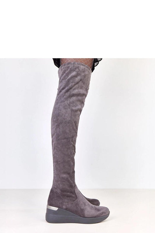Solea eco-suede knee-high boots with a modern design and metallic heel insert, perfect for pairing with trendy outfits.