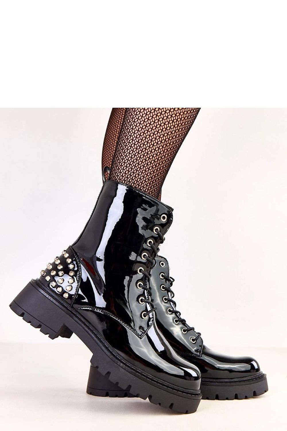 Solea Women's Patent Leather Booties featuring decorative studs, ankle height, and a 5.5 cm heel, showcasing a luxurious shine and modern rock-inspired design, ideal for stylish urban outfits.