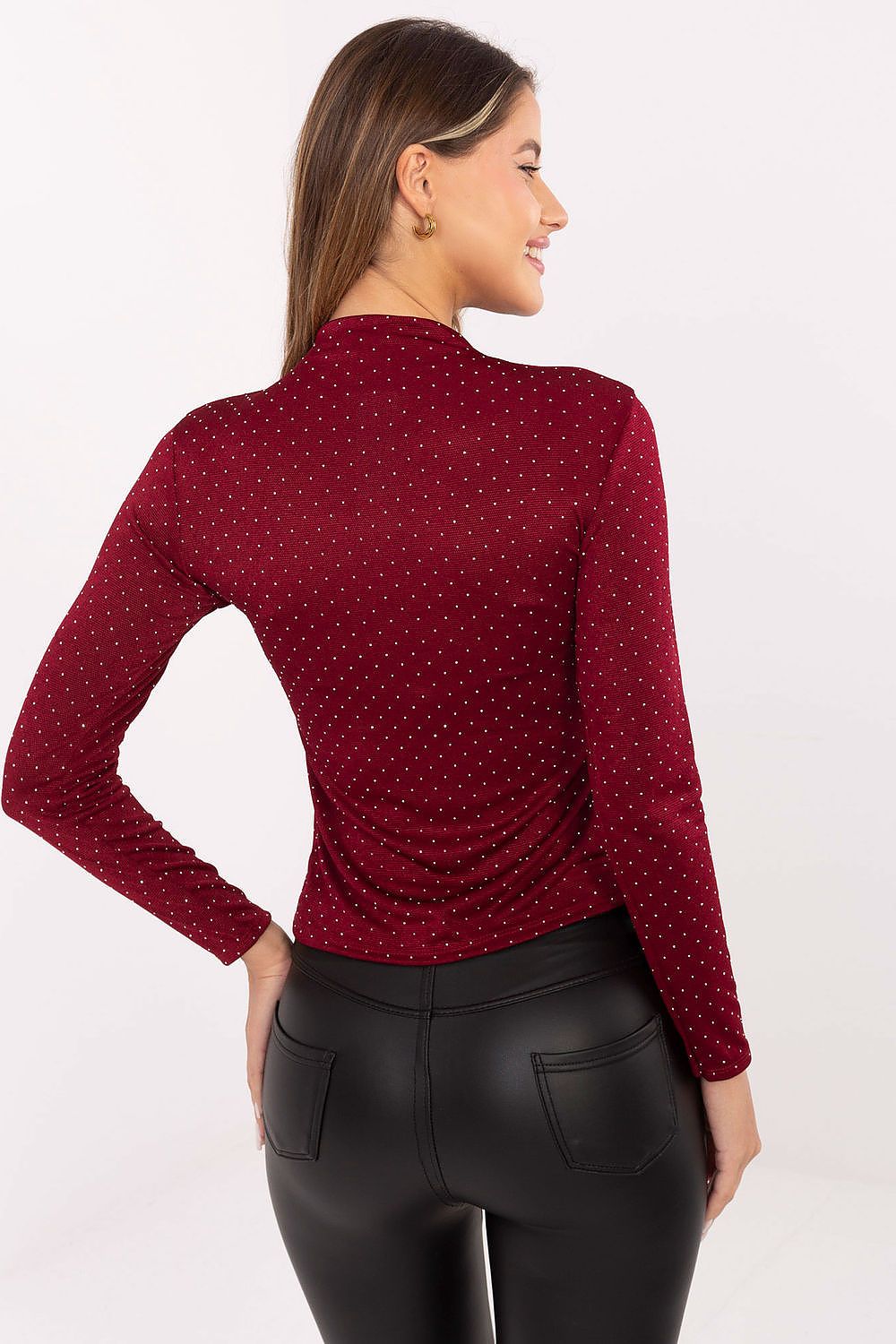 Model wearing a fitted turtleneck sequin blouse by Rue Paris, illustrating versatility in styling with skirts and elegant trousers.